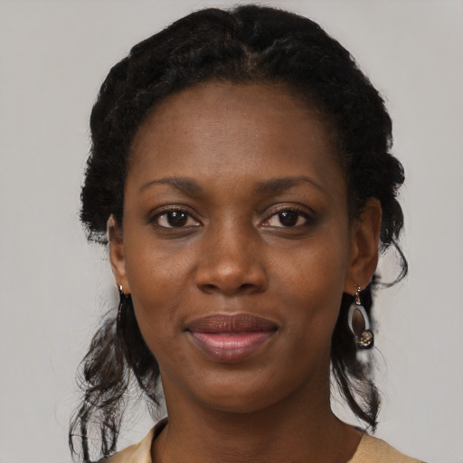 Joyful black young-adult female with medium  black hair and brown eyes