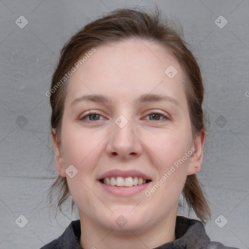 Joyful white young-adult female with medium  brown hair and blue eyes