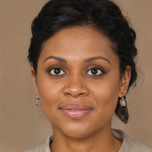 Joyful black young-adult female with medium  brown hair and brown eyes