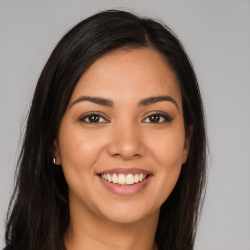 Joyful latino young-adult female with long  brown hair and brown eyes