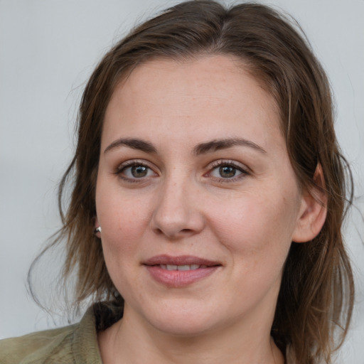 Joyful white young-adult female with medium  brown hair and grey eyes