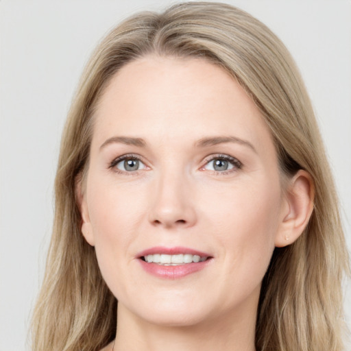 Joyful white young-adult female with long  brown hair and blue eyes