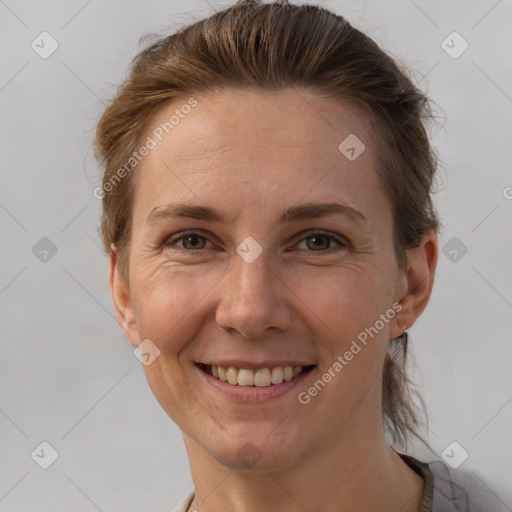 Joyful white adult female with short  brown hair and brown eyes