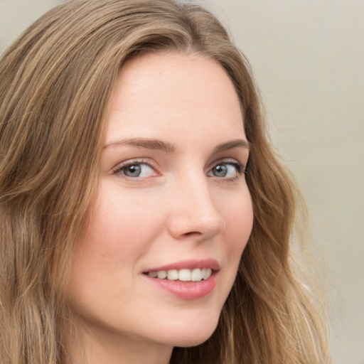 Joyful white young-adult female with long  brown hair and green eyes