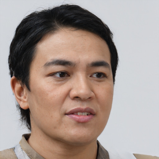 Joyful asian young-adult male with short  black hair and brown eyes