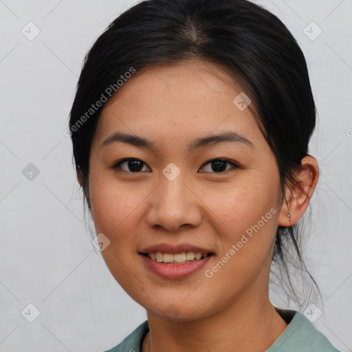 Joyful asian young-adult female with medium  black hair and brown eyes