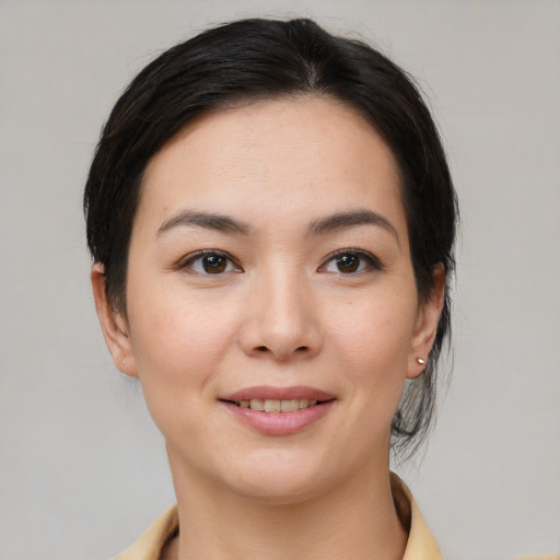 Joyful asian young-adult female with medium  brown hair and brown eyes