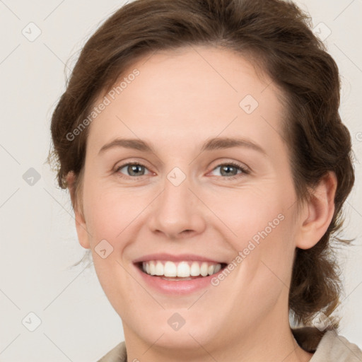 Joyful white young-adult female with medium  brown hair and grey eyes