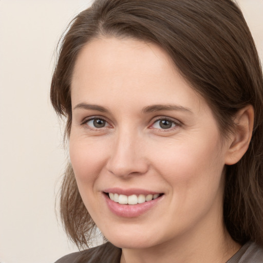 Joyful white young-adult female with medium  brown hair and brown eyes