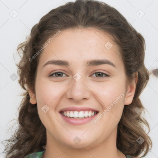 Joyful white young-adult female with long  brown hair and green eyes