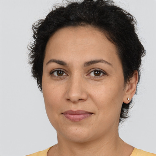 Joyful latino adult female with short  brown hair and brown eyes