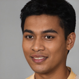 Joyful latino young-adult male with short  black hair and brown eyes