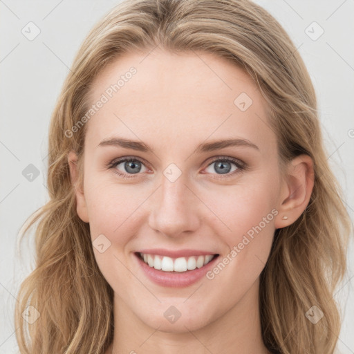 Joyful white young-adult female with long  brown hair and blue eyes