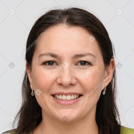 Joyful white adult female with medium  brown hair and brown eyes