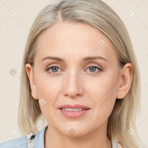 Joyful white young-adult female with medium  brown hair and blue eyes