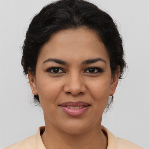 Joyful latino young-adult female with short  brown hair and brown eyes