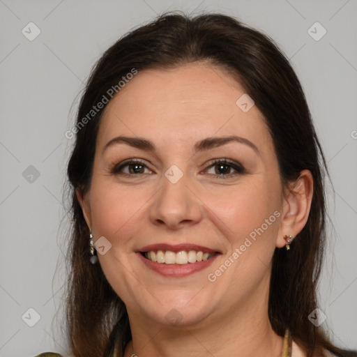 Joyful white adult female with medium  brown hair and brown eyes