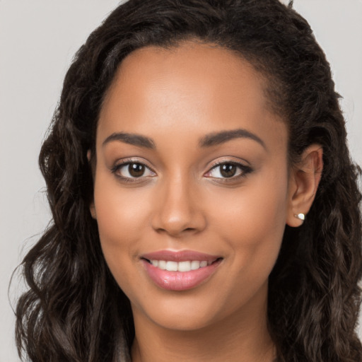 Joyful latino young-adult female with long  brown hair and brown eyes