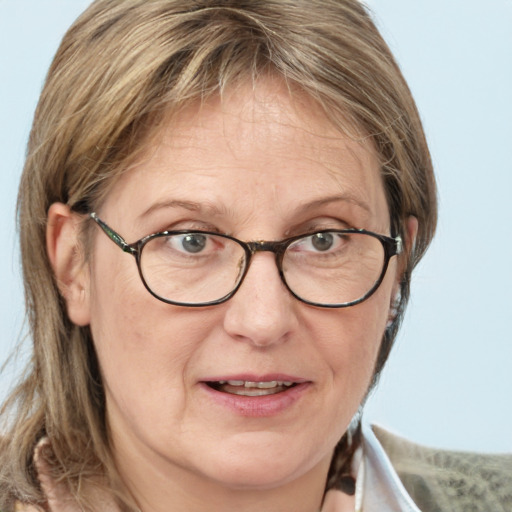 Joyful white adult female with medium  brown hair and blue eyes