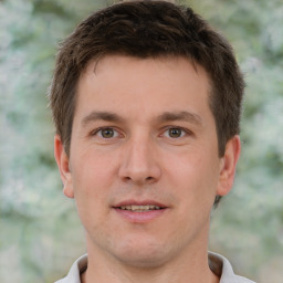 Joyful white young-adult male with short  brown hair and brown eyes