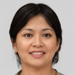 Joyful asian adult female with medium  brown hair and brown eyes