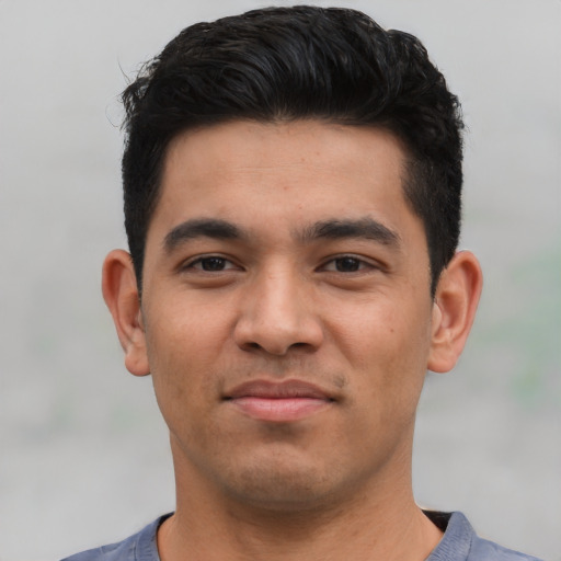 Joyful asian young-adult male with short  black hair and brown eyes