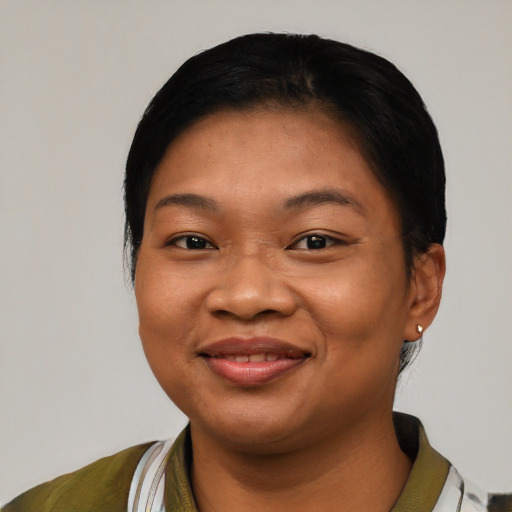 Joyful latino young-adult female with short  black hair and brown eyes