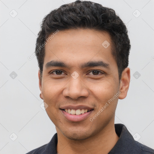 Joyful latino young-adult male with short  black hair and brown eyes