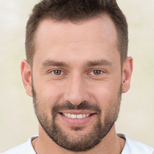 Joyful white young-adult male with short  brown hair and brown eyes