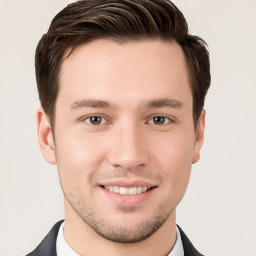 Joyful white young-adult male with short  brown hair and brown eyes