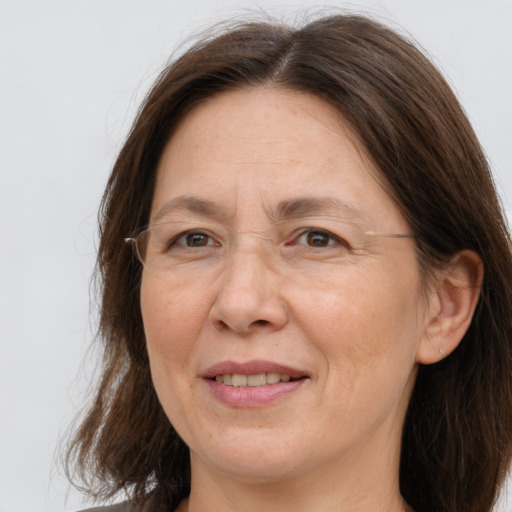 Joyful white adult female with long  brown hair and brown eyes