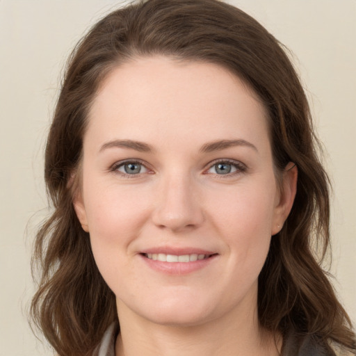 Joyful white young-adult female with long  brown hair and grey eyes