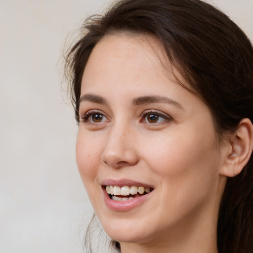 Joyful white young-adult female with medium  brown hair and brown eyes