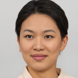 Joyful asian young-adult female with short  brown hair and brown eyes