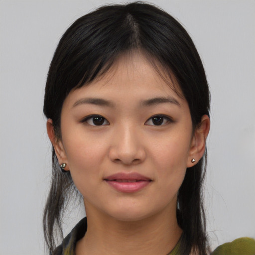 Joyful white young-adult female with medium  black hair and brown eyes