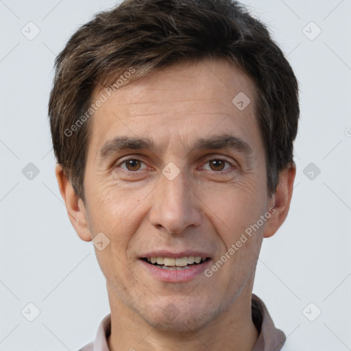 Joyful white adult male with short  brown hair and brown eyes