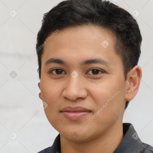 Joyful latino young-adult male with short  brown hair and brown eyes