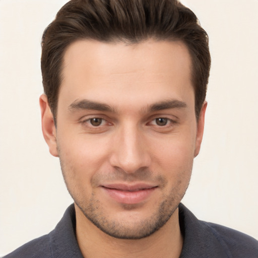 Joyful white young-adult male with short  brown hair and brown eyes