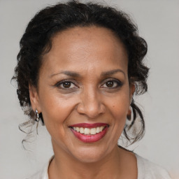 Joyful black adult female with medium  brown hair and brown eyes