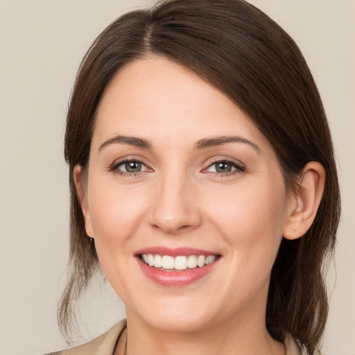 Joyful white young-adult female with medium  brown hair and brown eyes