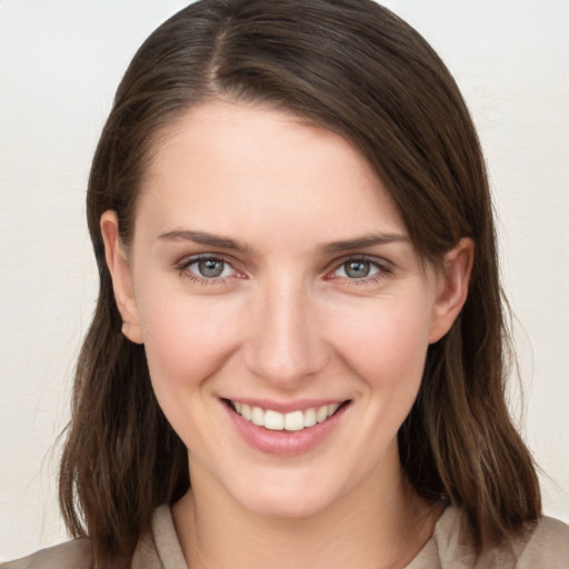 Joyful white young-adult female with medium  brown hair and grey eyes