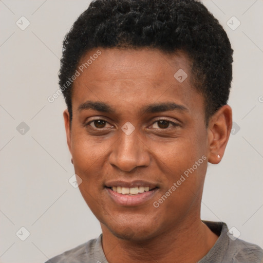 Joyful black young-adult male with short  black hair and brown eyes