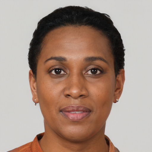 Joyful black adult female with short  black hair and brown eyes