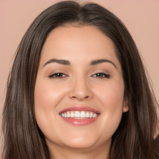 Joyful white young-adult female with long  brown hair and brown eyes