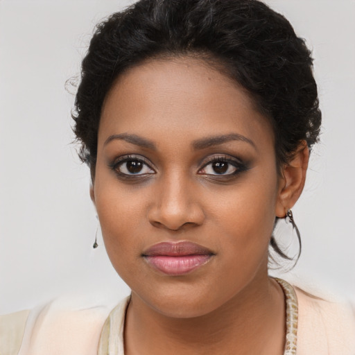 Joyful black young-adult female with long  brown hair and brown eyes