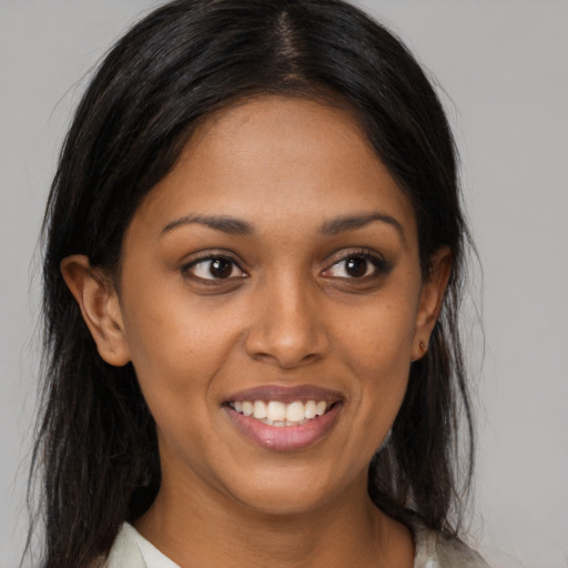 Joyful black young-adult female with medium  brown hair and brown eyes