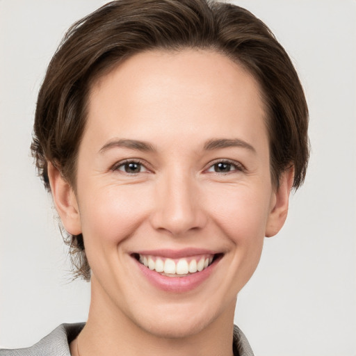 Joyful white young-adult female with short  brown hair and brown eyes