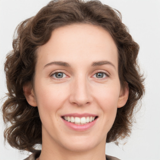 Joyful white young-adult female with medium  brown hair and green eyes