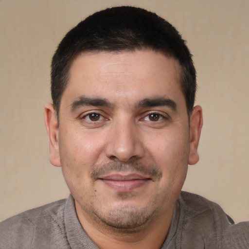 Joyful white young-adult male with short  black hair and brown eyes