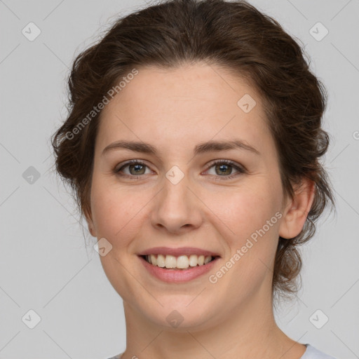 Joyful white young-adult female with medium  brown hair and green eyes